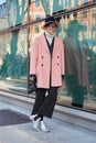 Woman with pink coat and silver shoes before Emporio Armani fashion show, Milan Fashion Week street style on