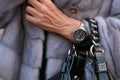Woman with Rolex Submariner watch and gray fur coat before Salvatore Ferragamo fashion show, Milan Fashion Royalty Free Stock Photo