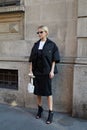 Caro Daur in black and white Prada clothing before Prada fashion show, Milan Fashion Week street style on June 17