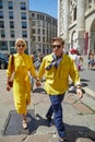 Caroline Daur and Carlo Sestini in yellow walking before Salvatore Ferragamo fashion show, Milan Fashion Week