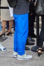 Man with blue trousers and Puma sneakers before Alberta Ferretti fashion show, Milan Fashion Week street style on Royalty Free Stock Photo