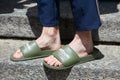 Man with green Reebok open sleepers before Salvatore Ferragamo fashion show, Milan Fashion Week street style on