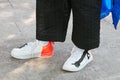 Man with white, orange and black Nike before Emporio Armani fashion show, Milan Fashion Week street style on June