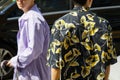 Men with purple striped shirt and black shirt with yellow flowers before Isabel Benenato fashion show, Milan