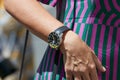 Woman with IWC Aquatimer watch and green and purple dress before Salvatore Ferragamo fashion show, Milan Fashion