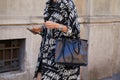 Woman with Rolex watch and black and white Lanvin jacket before Prada fashion show, Milan Fashion Week street
