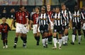 The Milan and Juventus players enter the field before the match