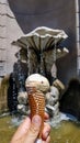 Milan - Male tourist holding a cone of ice cream in front of a fountain near Milan Cathedral Royalty Free Stock Photo