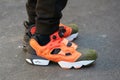 Man with Reebok sport shoes in orange, white and green olive colors before Fendi fashion show, Milan Fashion