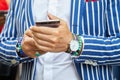 Man with Smart Tornout watch, turquoise bracelet and blue and white striped jacket before Ermanno Scervino Royalty Free Stock Photo