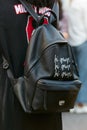 Woman with black leather backpack with eye design before Sportmax fashion show, Milan Fashion Week street