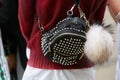 Woman with black leather backpack with studs before Fendi fashion show, Milan Fashion Week street style on