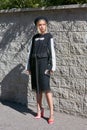 Woman with black and white dress and pink shoes before Alberto Zambelli fashion show, Milan Fashion Week