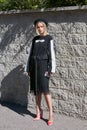 Woman with black and white dress and pink shoes before Alberto Zambelli fashion show, Milan Fashion Week