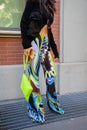 Woman with blue floral design trousers and yellow fluo bag before Fendi fashion show, Milan Fashion Week
