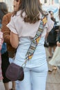 Woman with ethnic design shoulder strap before Luisa Beccaria fashion show, Milan Fashion Week street style