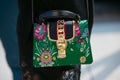 Woman with green Gucci bag with floral design and golden details before Gabriele Colangelo fashion show,
