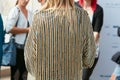Woman with jacket with gold and pearls decoration before Gabriele Colangelo fashion show, Milan Fashion Week