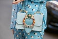 Woman with pale blue jewel bag before Prada fashion show, Milan Fashion Week street style on September 22, Royalty Free Stock Photo