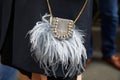 Woman with Patrizia Pepe small gray bag with feathers and gems decoration before Blumarine fashion show,