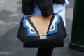 Woman with Pimko bag in black, blue and white colors before Wunderkind fashion show, Milan Fashion Week