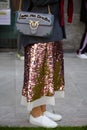 Woman with Pinko Love me tender bag and pink sequin skirt before Giorgio Armani fashion show, Milan Fashion