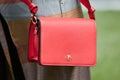 Woman with red Patrizia Pepe leather bag before Giorgio Armani fashion show, Milan Fashion Week street style
