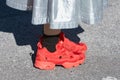 Woman with red Reebok sneakers and silver metallic skirt before Alberto Zambelli fashion show, Milan Fashion