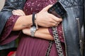 Woman with Rolex Air King watch, Cartier bracelet holding iPhone in hand before Antonio Marras fashion show