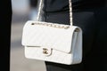 Woman with white Chanel leather bag before Gabriele Colangelo fashion show, Milan Fashion Week street style