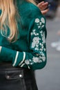 Woman with white flowers embroidery on green shirt before Salvatore Ferragamo fashion show, Milan Fashion