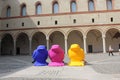 Milan Sforza Castle courtyard with three colorful birds