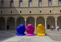 Milan Sforza Castle courtyard with three colorful birds