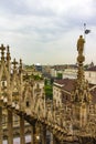 Milan skyline spires and statue of Duomo di Milano Italy