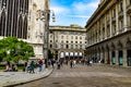 Milan street panorama with Milan trams, pedestrians and cars on a sunny day