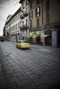 Milan street scene with motion blur on Italian car