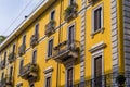 The sun reflects cheerfully on Milanese yellow building in the China Town district.