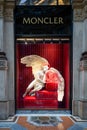 Moncler shop in Galleria Vittorio Emanuele II, Milan, beautiful window in Pre-Christmas time decorated with angel and red curtain.