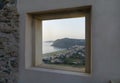 Milazzo city coast at sunset viewed through a window