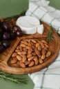 Mildewed cheese, nuts and grapes. A tasty and healthy dish on a green background. Useful and healthy food