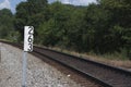 Sign post for a mile marker on a railroad track Royalty Free Stock Photo