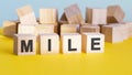 mile word construction with letter blocks and a shallow depth of field