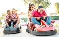 Milenial friends having fun at children playground on go kart race - Young people with face mask competing on mini car racing Royalty Free Stock Photo