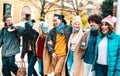 Milenial people walking and having fun together wearing open face mask at old town - New normal lifestyle concept with Royalty Free Stock Photo