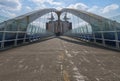 People crossing the Millennium bridge, Salford Quays, Manchester, England. Royalty Free Stock Photo