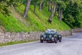 1000 Miles 2019, Brescia - Italy. May 15, 2019: The historic Mille Miglia car race. A couple rushing in a beautiful green vintage