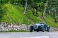 1000 Miles 2019, Brescia - Italy. May 15, 2019: The historic Mille Miglia car race. A couple rushing in a beautiful green vintage