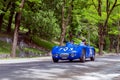 1000 Miles 2019, Brescia - Italy. May 15, 2019: The historic Mille Miglia car race. Two men rushing in a beautiful blu vintage