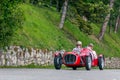 1000 Miles 2019, Brescia - Italy. May 15, 2019: The historic Mille Miglia car race. Two men rushing in a beautiful red vintage