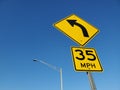 35 miles per hour left right turn sign clear sky